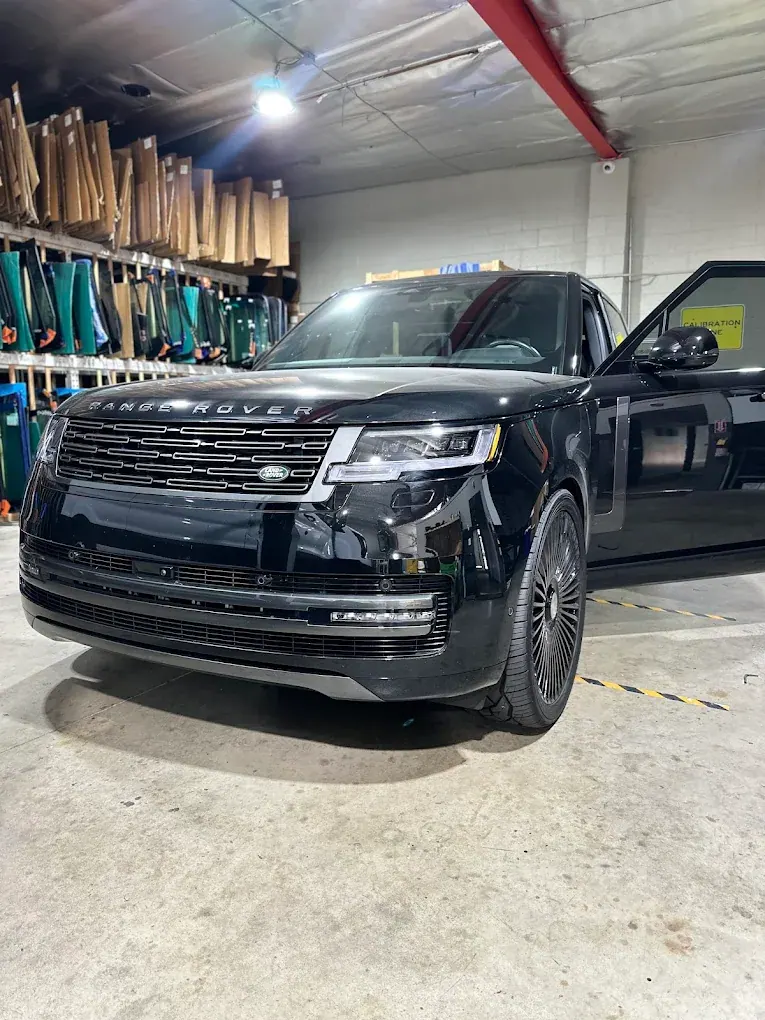 Black Range Rover parked inside the PG Auto Glass shop